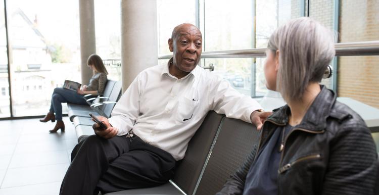 Man and woman sitting in a doctors waiting room