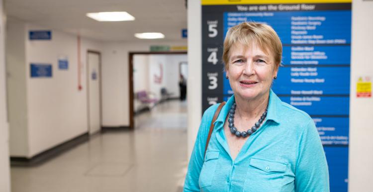 Woman standing in a hospital corridor