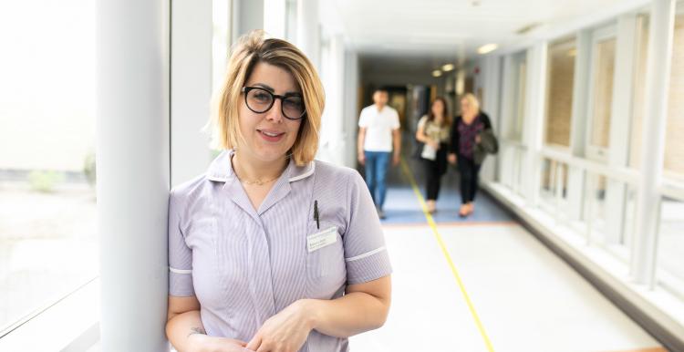 nurse standing in a hospital corridor