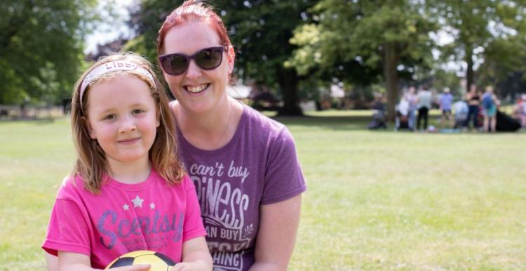 Young mum and her daughter in a park