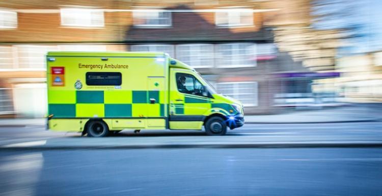 An ambulance speeding down a road