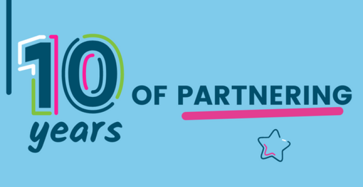 Text ID: 10 years of partnering. A small star hovers under the final word which is underlined in pink. 