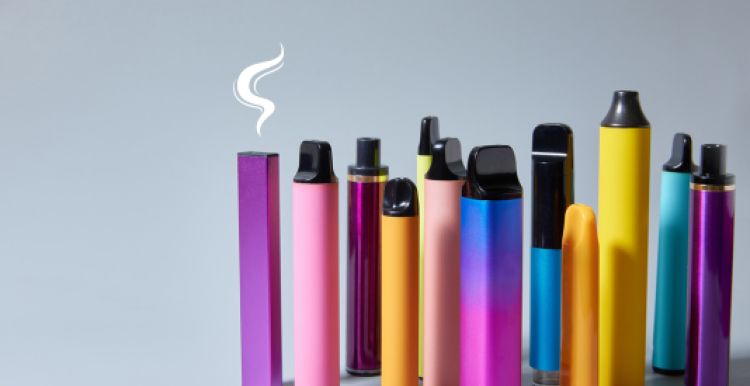 A group of colourful vapes arranged vertically. A smoke graphic hovers over the top of one.