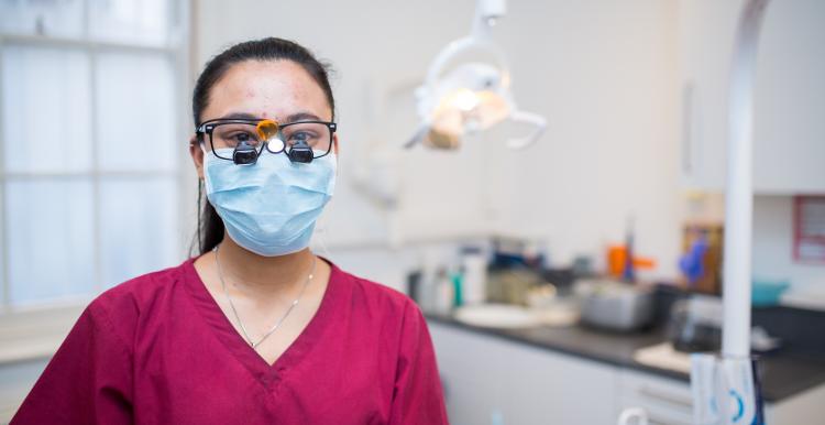 Dentist wearing goggles and mask