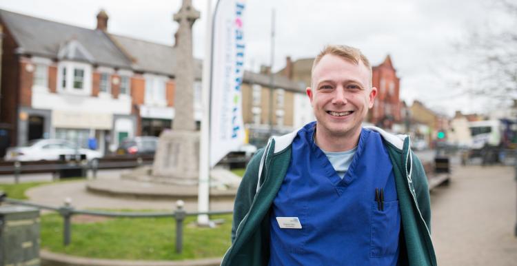 Man who works for the NHS standing outside at a Healthwatch community event