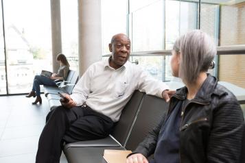 Man and woman sitting in a doctors waiting room