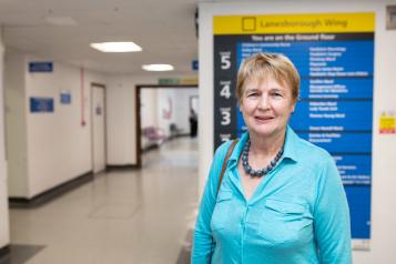 Woman standing in a hospital corridor