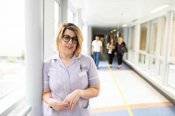 nurse standing in a hospital corridor
