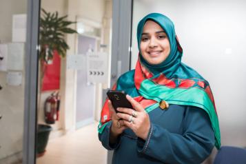 Muslim young women in traditional dress in doctors waiting area