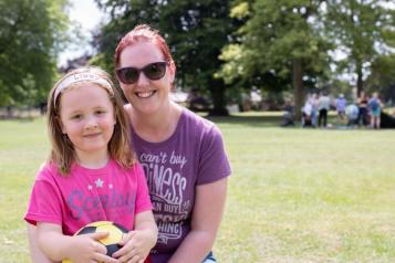 Young mum and her daughter in a park