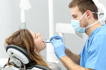 Dentist looking in a patient's mouth