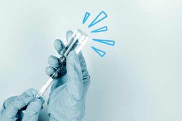 a vaccine being drawn into a needle from a vial. Around the vial are highlight lines to mark the vial as notable. 