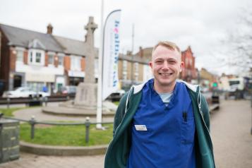 Man who works for the NHS standing outside at a Healthwatch community event