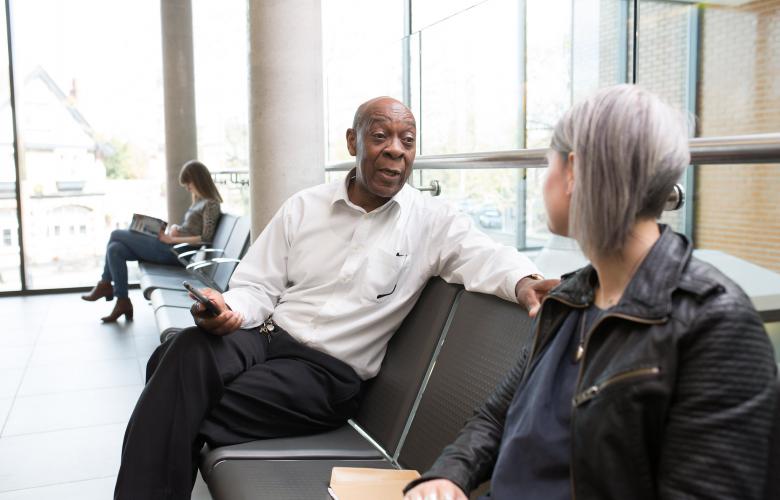 Man and woman sitting in a doctors waiting room